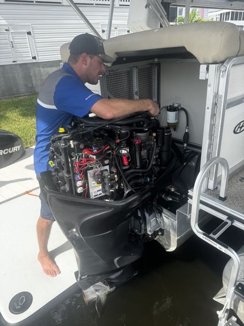 Chris working on an outboard at the dock